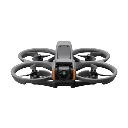 FPV drone kit shown with three batteries, charging hub, and controller on a table